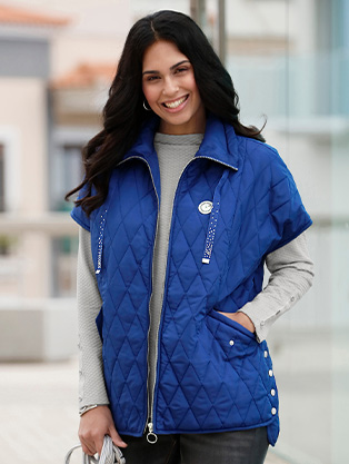 Woman wearing a quilted zip up vest.