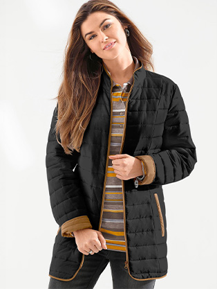 Woman wearing a quilted puffer jacket.