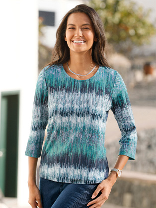 Woman wearing a printed 3/4 sleeve shirt.