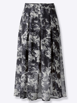 Woman wearing pleated floral skirt.