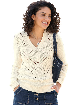 Woman wearing a open knit sweater.