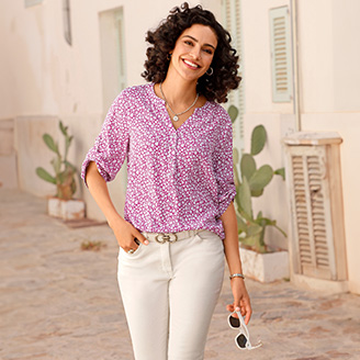 Woman wearing a Floral Tab Sleeve Blouse.